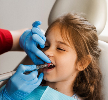 Young girl having her teeth cleaned