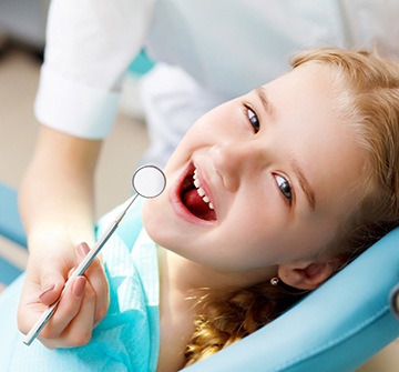 Child smiling while visiting pediatric dentist in Nashua