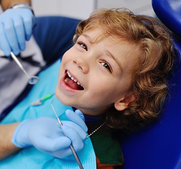 Child smiling while visiting pediatric dentist near Nashua