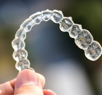 Closeup of Invisalign tray in Nashua on colorful background