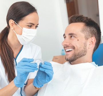 Patient and dentist discussing how much Invisalign costs in Nashua