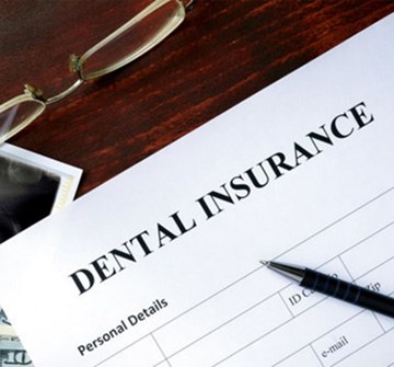 a patient filling out a dental insurance form 