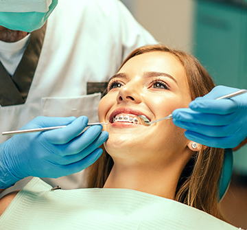 Patient holding up Invisalign in Nashua