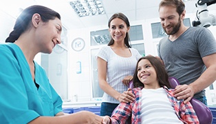 Dental team member parents and child in dental treatment room