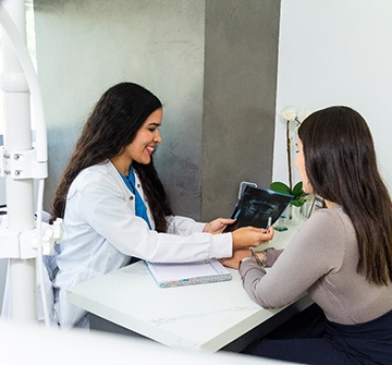 Adult patient talking to dentist
