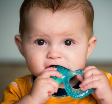 baby chewing on teething ring 
