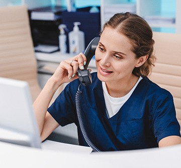 Friendly dental team member talking on phone