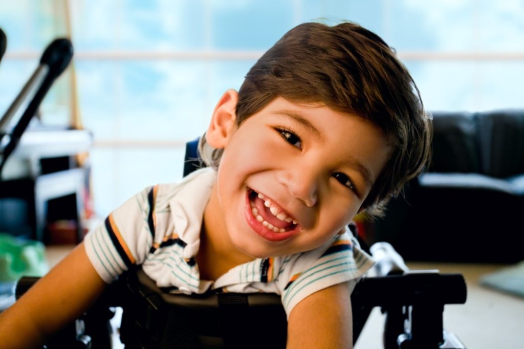 Closeup of boy with special needs smiling in walker