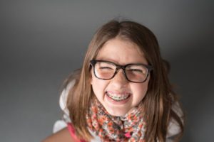 a kid with braces smiling 