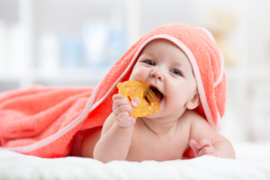 a child biting a teething toy