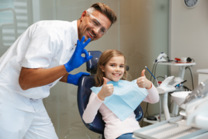a child smiling while visiting the dentist