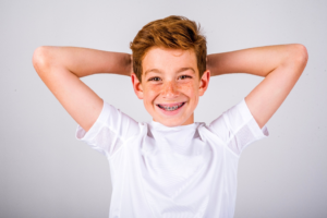 a child with braces smiling confidently 