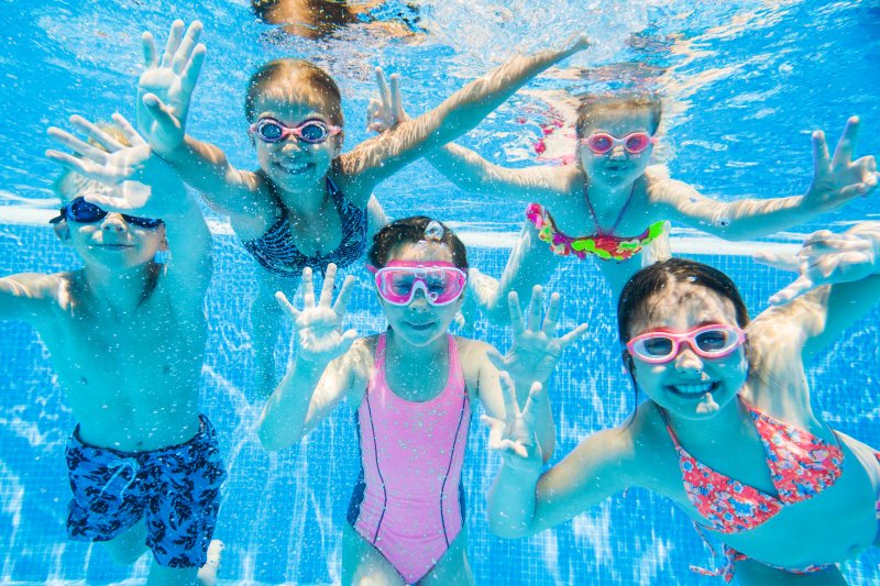 group of children swimming in a pool