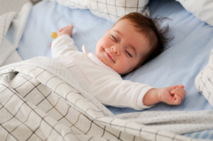 a smiling baby sleeping peacefully